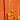 Orange tall candles sit in real oranges to create a Mediterranean table centrepiece.