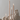 Four lit Hall of Flame Sand Beige Cathedral Candles stand tall in light sand on a neutral background.
