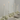 The Hall of Flame Antique Wedding Bundle features tall white candles in silver holders, paired with neutral plates, bowls, and silverware atop a white tablecloth, all elegantly accented by white flowers.