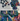 Twelve metallic hand-sprayed PRESERVED FLOWERS by Hall of Flame in blue, green, purple, and gold hues are displayed on a light background. Text: 12 Metallic Hand-Sprayed PRESERVED FLOWERS.