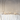 A spacious room features a long table with white florals, clear glassware, minimal tableware, and Hall of Flames Collection 6 | Pre-styled Bundle (8 Candles) in gold holders. Perfectly elegant for wedding table styling against a white arched wall.