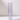A Hall of Flame Blue Coloured Glass Sleeve holds a tall candle upright on a white surface, set against a light gray background.