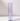 A Hall of Flame Blue Coloured Glass Sleeve holds a tall candle upright on a white surface, set against a light gray background.