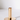 A Gold Plated Candle Holder features a minimalist design with a circular base, ideal for catching wax drips and matching modern decor.