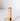 A Gold Plated Candle Holder features a minimalist design with a circular base, ideal for catching wax drips and matching modern decor.