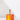 The Hall of Flame shiny Gold Plated Candle Holder, perfect for minimalistic decor, sits on top of an orange box.