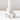 A close-up of the Hall of Flame White Flower Candle Holder, featuring ruffled petal details and crafted with advanced 3D print technology, holds a white candle against a plain white background.