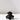 The SAMPLE | Black Flower Holder by Hall of Flame, featuring glossy black, petal-like ruffled edges, sits on a white surface and casts a soft shadow against a plain light background.