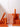 Four white taper candles of varying heights are displayed in clear holders, surrounded by stacked orange boxes labeled “25cm” and “35cm Candle Pair” against a white background.