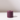 The Hall of Flame Jam Purple Wax Candle Holder is a cylindrical, sustainable, plant-based wax accessory with a central hole. Resting on a white surface, it casts a gentle rightward shadow against a simple background that highlights its elegance.