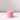 The Hall of Flame Petal Pink Wax Candle Holder is a solid pink cylinder with a central hole, shown on a white surface with a soft right-side shadow and plain light background—ideal for highlighting this elegant, sustainable wax holder.