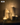 A group of six glass containers of varying heights, each filled with white sand and a lit candle inside, creating a warm and cozy glow. A NEW label appears in the top left corner.