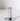 The Hall of Flame Silver Plated Candle Holder stands upright on a white surface, its sleek cylindrical design and flat base casting a subtle shadow—a minimalistic accent designed for XXL Tapers.