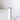 The Hall of Flame White Plated Candle Holder features a minimalist cylindrical design, standing vertically on a flat round base, perfect for XXL tapers. It casts a soft shadow against a simple white background.