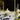 An elegant outdoor wedding table is set with Hall of Flame’s Olive Green Cathedral Candles.