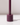 The Hall of Flame Jam Purple Wax Candle Holder features a cylindrical design with a central vertical rod, ideal for sustainable plant-based pillar candles. It casts a soft shadow on white surfaces against light backgrounds.