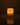 The Hall of Flame Pillar with Wax Sleeve glows warmly in a dark room, its gentle flame illuminating the space and casting a soft reflection on the smooth surface beneath its elegant wax sleeve.