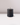 The Hall of Flame Black Votive Candle - 10 pack features natural wax candles with unlit wicks, perfect for pairing with crystal glass holders, and looks elegant on glossy white surfaces against a pale background.