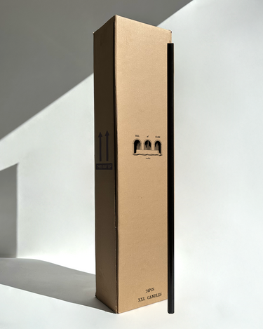 Extra-long black candle beside a wholesale tall box – ideal for weddings or bulk buy candles in Australia.