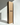 A tall Hall of Flame box labeled Bulk Candles - Wholesale box stands upright beside a single slender black candle.