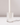 A white candle sits in the Hall of Flame Rectangle | Crystal Glass Candle Holder on a white surface, casting a soft shadow rightward. The plain background is softly lit.
