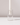 A white candle stands upright in the Hall of Flame Cylinder | Crystal Glass Candle Holder, displayed against a plain white background with soft lighting and subtle shadows.