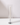 A Hall of Flame Glass Candle Sleeve encases a white taper candle in a silver holder.