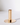 A Gold Plated Candle Holder features a minimalist design with a circular base, ideal for catching wax drips and matching modern decor.
