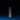 Two SAMPLE SALE | LED Candles by Hall of Flame stand upright on a blue surface, casting long shadows. Their small flames glow brightly against a dark background, highlighting the elegance of these white taper candles.