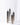 Four tall, rectangular Hall of Flame Mirror Plinths of varying heights, each holding a slim white taper candle, are arranged together against a plain white background. Custom orders for these elegant pieces are also available.