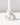 A close-up of the Hall of Flame White Flower Candle Holder, featuring ruffled petal details and crafted with advanced 3D print technology, holds a white candle against a plain white background.