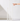 Four Hall of Flame White | Realistic LED Flameless Taper Candles of different heights stand on a white surface. A hand enters from the right to touch the tallest candle’s lifelike flame.