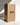 A tall beige candle stands beside a large Hall of Flame “Bulk Candles | Wholesale by-the-box” carton, featuring a vintage archway—ideal for weddings or anyone seeking bulk buy candles from this trusted Australian brand.