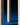 Close-up of a cream ULTRABRIGHT™ LED Flameless Taper Candle by Hall of Flame standing upright on a blue surface against a dark background, with "Hall of Flame" embossed vertically.