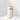 A cylindrical kraft paper container labeled SANDWAX Scented Candle Refill by Hall of Flame stands upright on a white surface with small piles of white powder. Its minimalist label features a line drawing of a candle and the scent FIG BOIS.