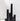 The Hall of Flame XXL Pillar Candle Bundle features five unscented black cylindrical candles of varying heights, elegantly arranged on a white surface with a plain white background and gentle shadows.