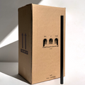 A tall box labeled Hall of Flame Bulk Candles | Wholesale by-the-box stands upright with a single long black candle leaning against it, both casting shadows on a white background—ideal for wholesale candle orders across Australia.