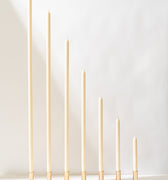 Eighteen cream-colored taper candles from Hall of Flame's Collection 1 Pre-styled Bundle are arranged in shiny gold holders against a white background—ideal for wedding collections or as an XXL Wedding Candle bundle.